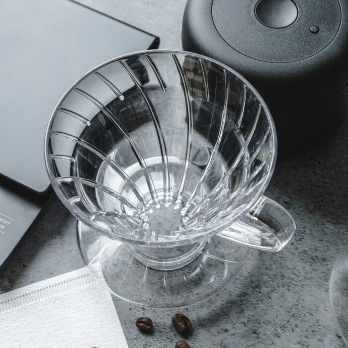 The Hario V60 Coffee Dripper is a classic and affordable option for coffee enthusiasts. Made from high-quality transparent plastic, this dripper offers excellent thermal stability compared to its ceramic or metal counterparts. The clear plastic material is lightweight yet durable, making it perfect for everyday use. To ensure optimal brewing results, we recommend pre-heating your brewing equipment before brewing. Simply pour some hot water onto your brewing setup before adding your coffee grinds. This not only preheats your brewing setup but also washes out the paper filter to ensure there's no paper taste in your brew. In the box, you'll find the Hario V60 Dripper in your choice of Clear Plastic '01' or '02', along with a Hario coffee scoop. With its sleek design and superior performance, the Hario V60 Coffee Dripper is the perfect addition to any coffee lover's collection. Upgrade your coffee brewing experience with the Hario V60 Coffee Dripper - lightweight, durable, and affordably priced. Included in the box is: 1x Hario V60 Dripper - Clear Plastic '01' or '02' 1x Hario coffee scoop