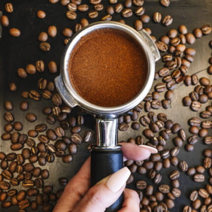 Womans Hand With Beautiful Nails And Holding Portafilter With Coffee