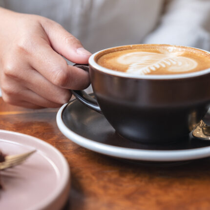 Closeup Image Of A Womans Hand Holding And Drinking Hot Latte C