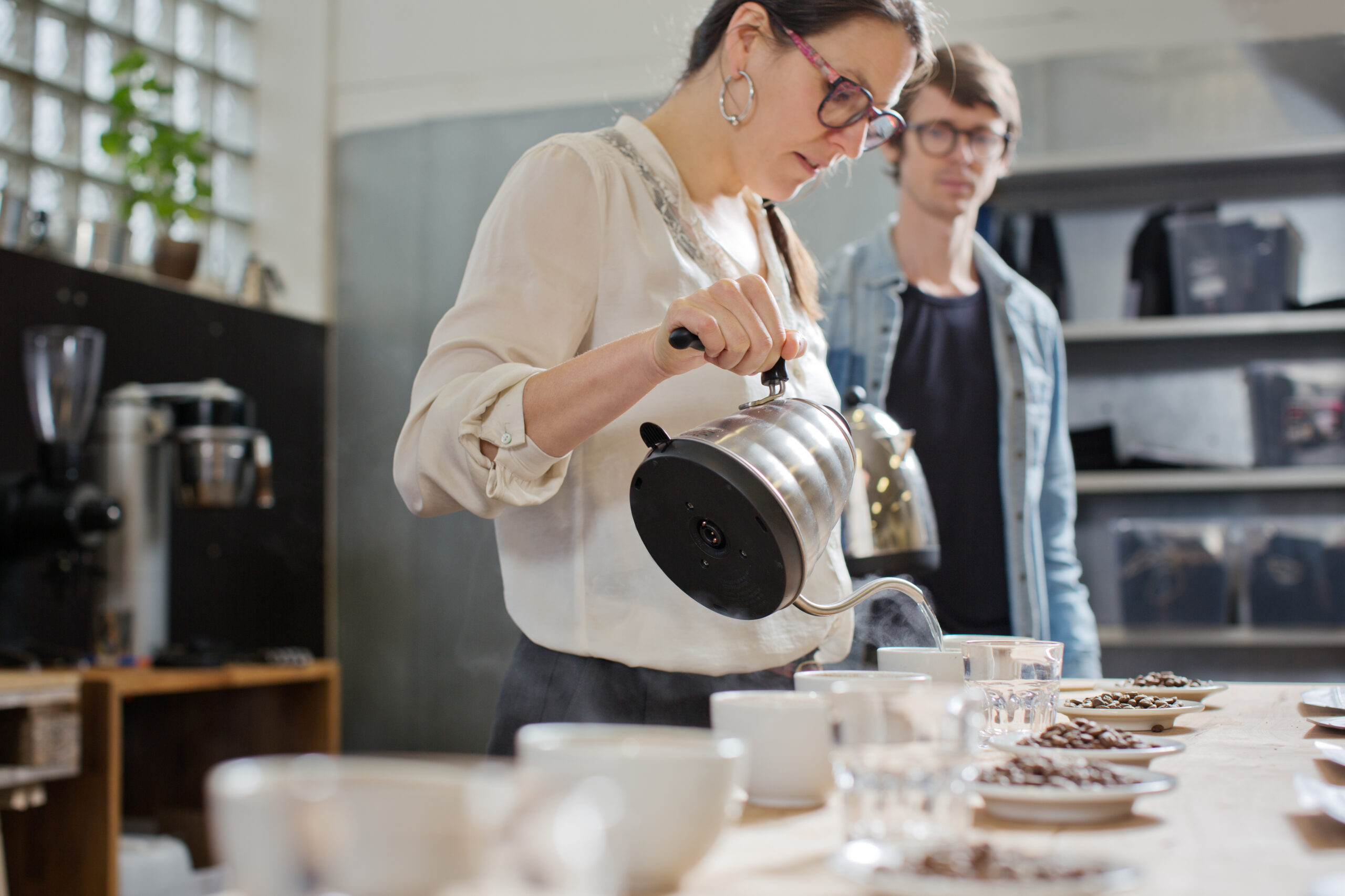 Coffee Taster Pouring Hot Water Into Cup Of Coffee